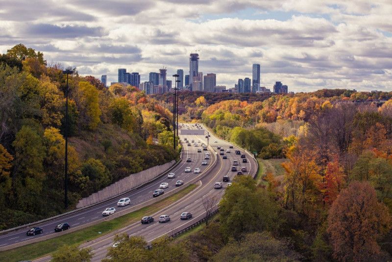 Cars on a motorway with Toronto City in the background. 