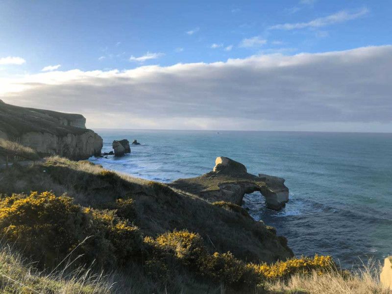 Enjoy the sunset at the Tunnel Beach.
