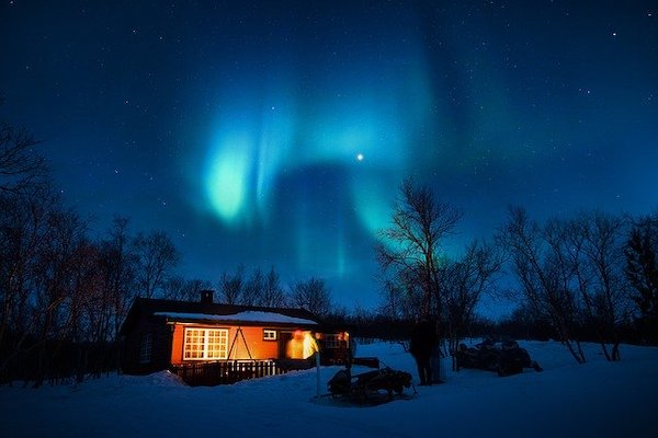 Catch a glimpse of the Northern Lights (Aurora Borealis) in a dark, clear night sky.